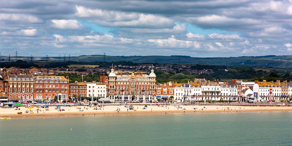 Historic buildings lining the promenade at Weymouth Beach