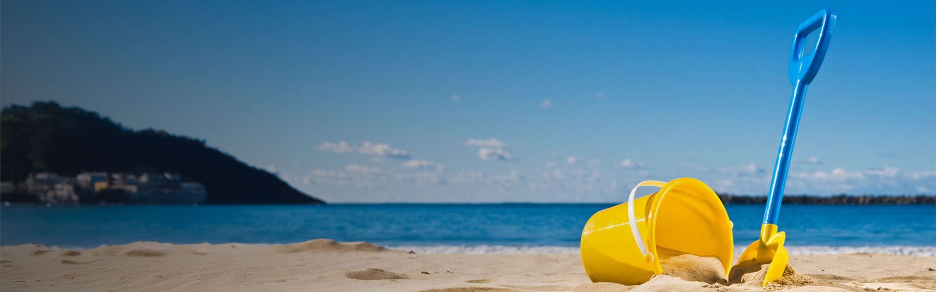 A bucket and spade on a sandy beach