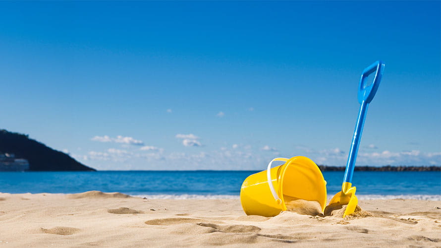 A bucket and spade on a sandy beach