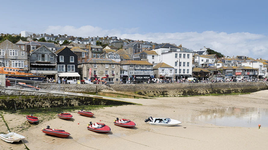 Boats beached in the harbour at low tide in St Ives