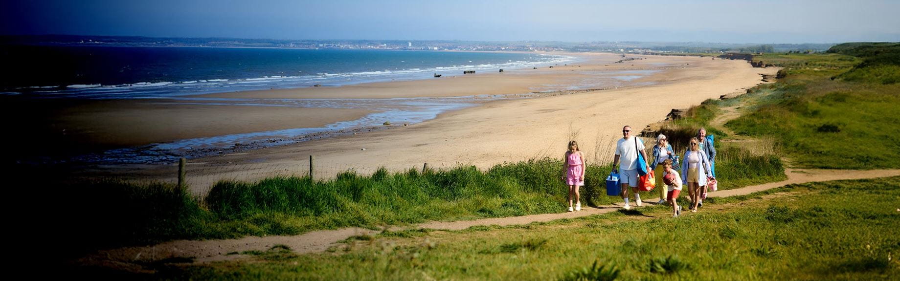Family walking along a coastal path