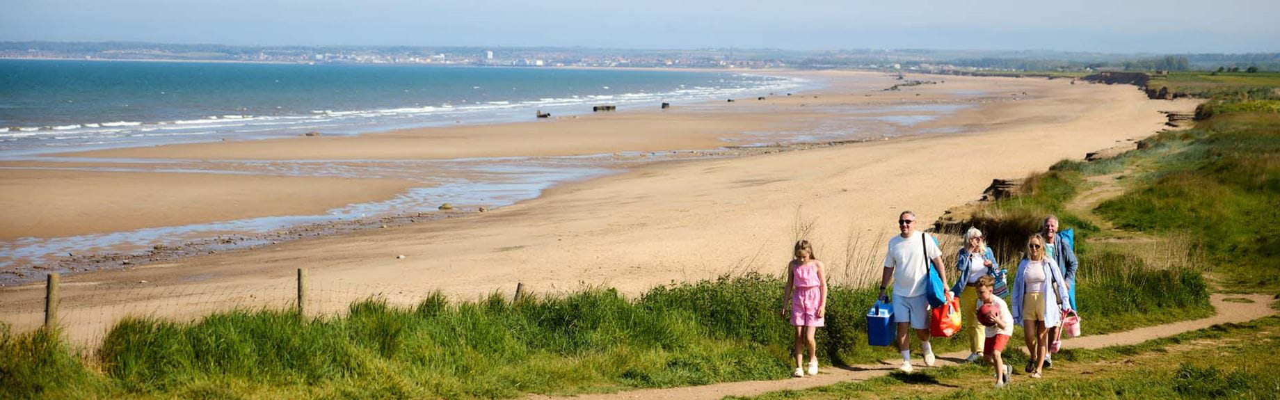 Family walking along a coastal path