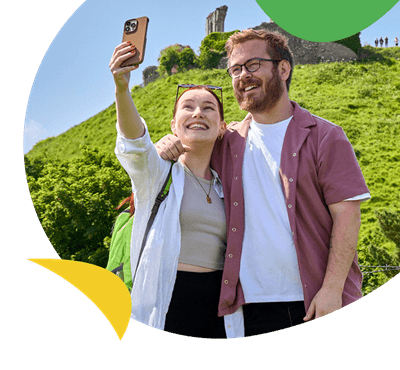 A couple posing for a selfie while exploring Dorset's attractions
