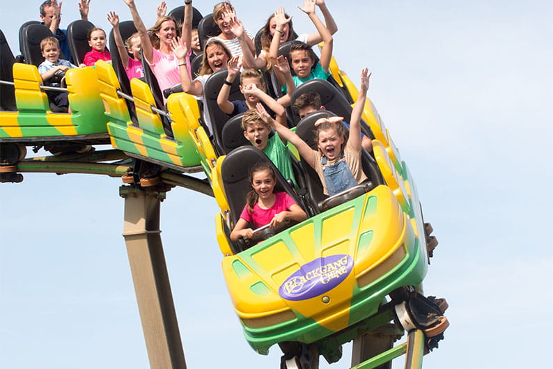 Children riding a rollercoaster at Blackgang Chine theme park