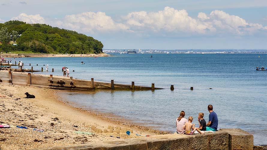 A family sitting on a pier on the Isle of Wight