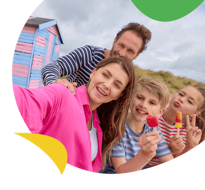 A family posing for a selfie at the beach