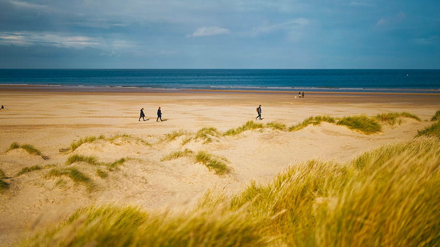 Walkers and dunes at Holkham Beach