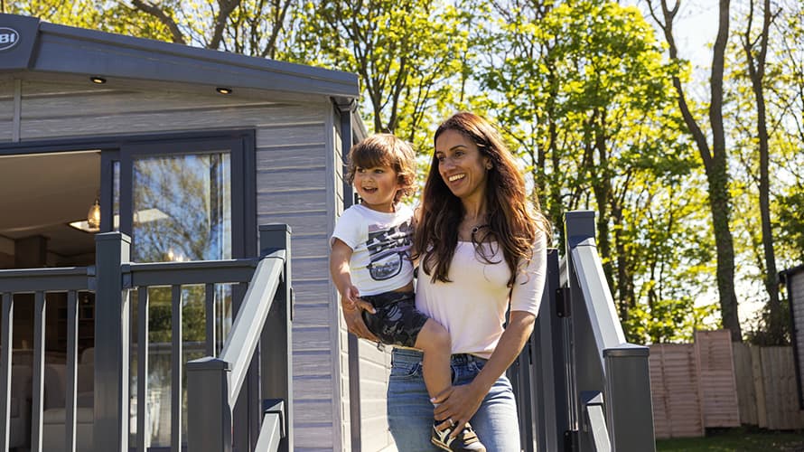 A mother and her son exploring their caravan accommodation