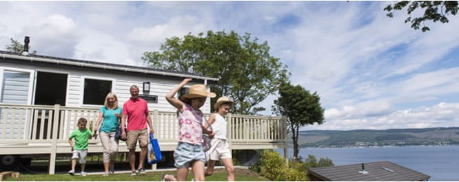 A family walking out of their caravan by the sea