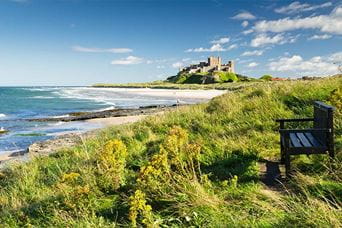 A view over the grassy dunes towards Bamburgh Castle