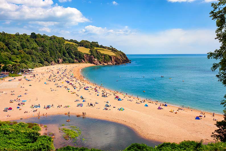 Families enjoying a summer day on Blackpool Sands beach
