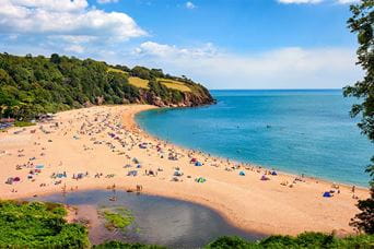 Families enjoying a summer day on Blackpool Sands beach
