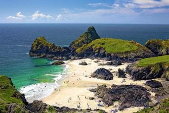 Families enjoying the beach on a sunny day at Kynance Cove