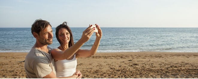 Couple taking a selfie on the beach