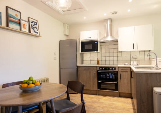 Grey kitchen with white subway tiles and laminate flooring