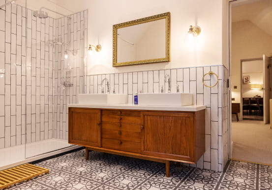 Wooden bathroom cabinet with floral black and white tiles