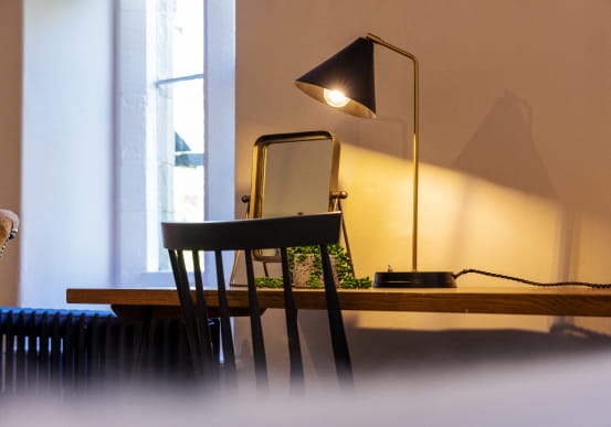 Wooden desk with task lamp and chair