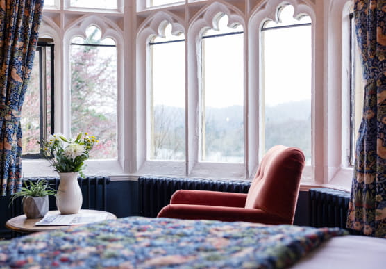 Orange armchair in the window over looking Lake Windermere