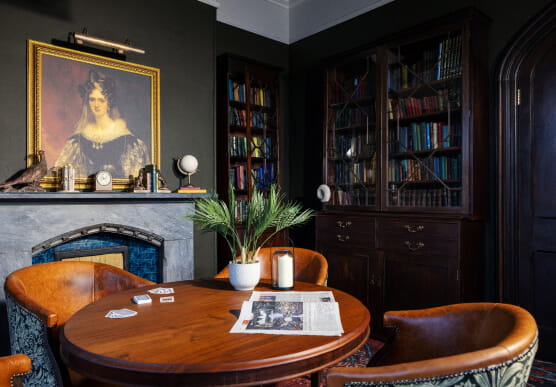 Dark library with round table and chairs
