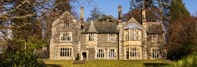 External image of Fallbarrow Hall in the bright blue sky