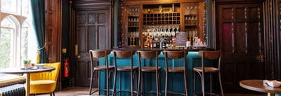 Dark blue themed bar with trendy bar stools