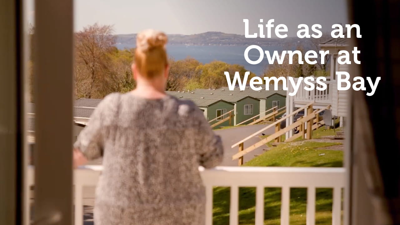 Woman looking out at Parkdean Resorts caravan park