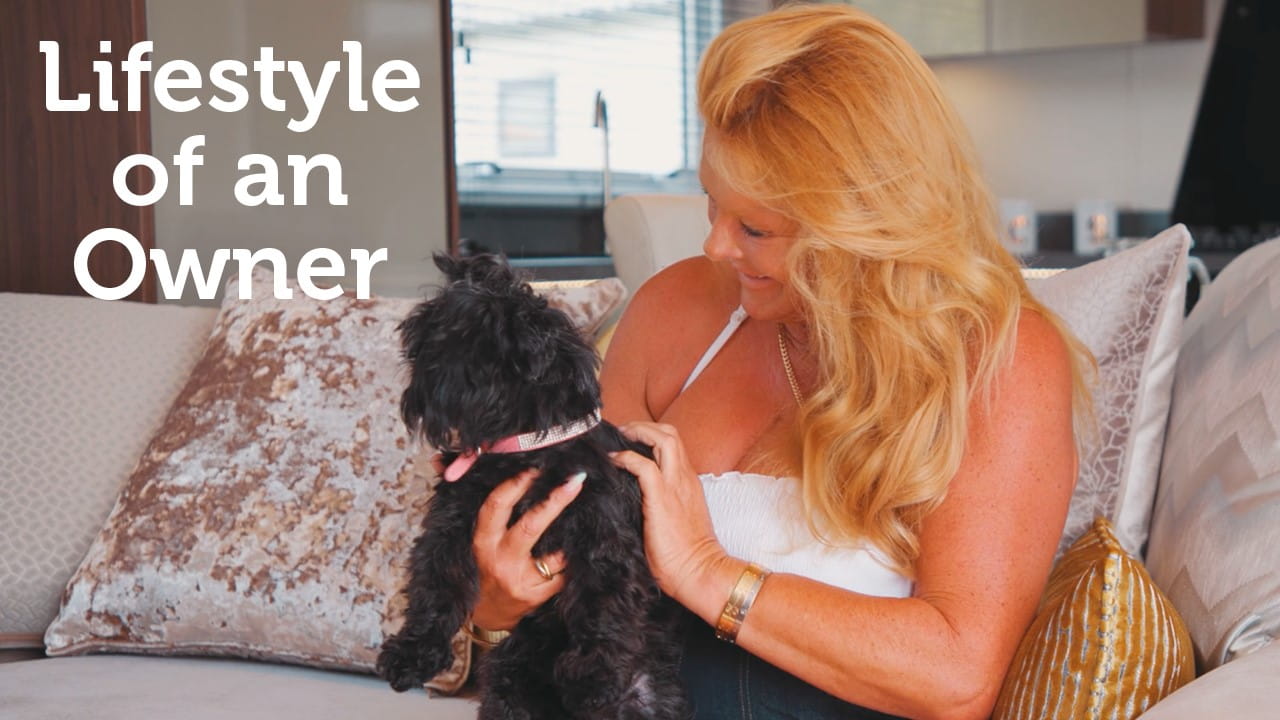 Woman sat with a black dog on her lap