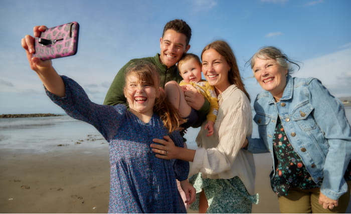 Family taking selfie on the beach