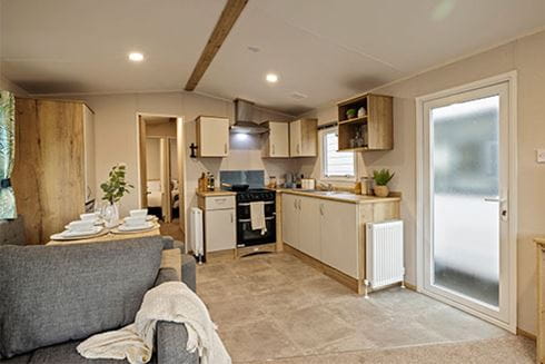 The interior of a used static caravan, showing the kitchen and living room
