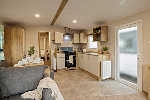 The interior of a used static caravan, showing the kitchen and living room
