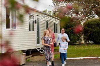 A family exiting their pre owned holiday home
