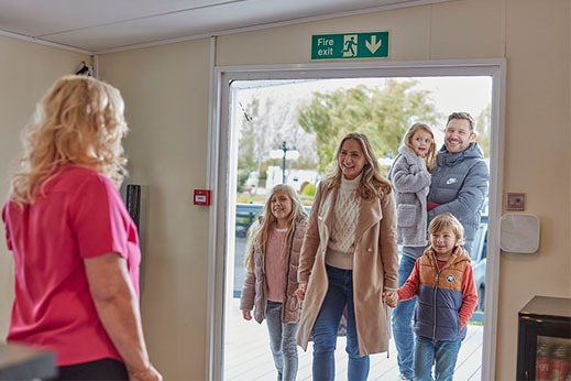 A family being greeted by the team on park after buying a used caravan
