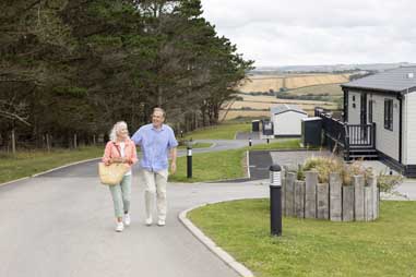 A couple walking past a holiday home in  Cornwall