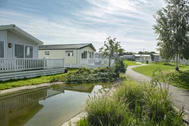 Holiday homes overlooking a pond in Norfolk
