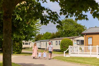 A family walking past caravans for sale in Essex