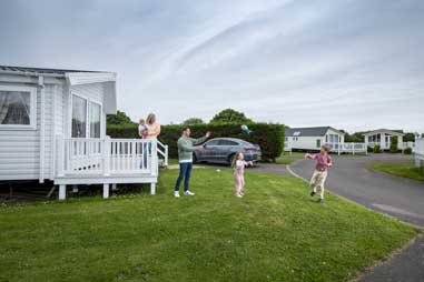 A family playing outside their holiday home in Yorkshire