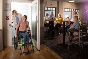 a person in a wheelchair going into a bar