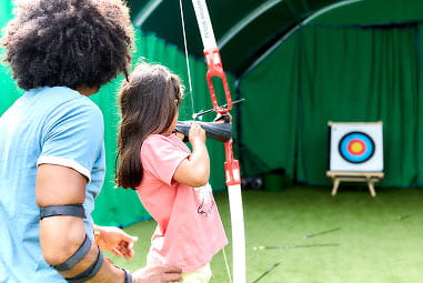 Young girl playing archery