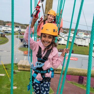 Girl climbing high ropes