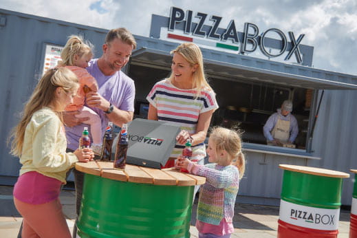 Family eating pizza from Pizza Box at Parkdean Resorts