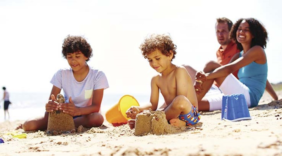 a family building sandcastles on the beach