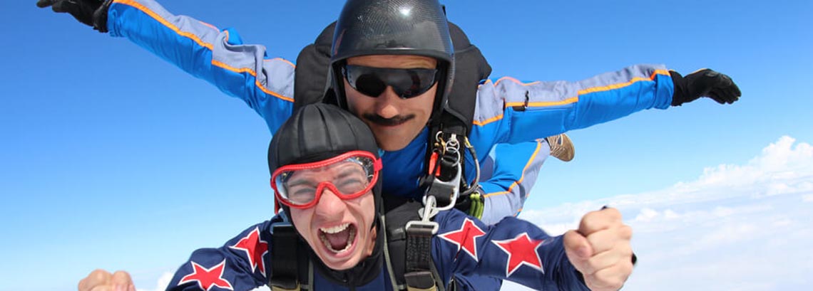 Two people skydiving out of a plane
