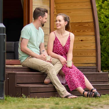 couple sitting outside a glamping tent together