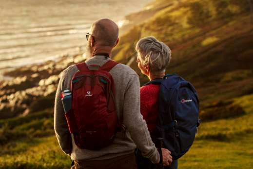 couple looking out across a body of water at sunset