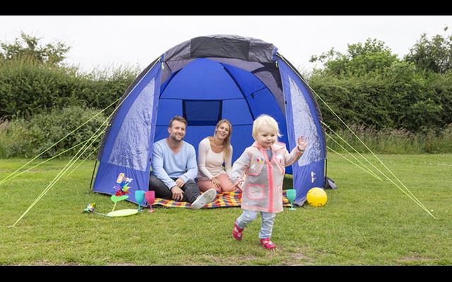 Family camping in a tent at Parkdean Resorts