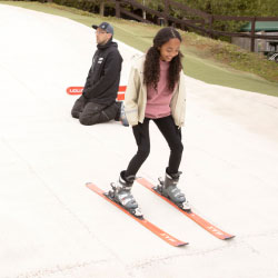 a girl on skis on a ski slope