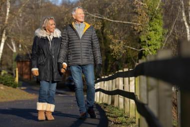 an older couple walking hand in hand