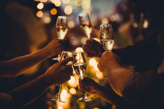 an abstract image of 5 arms holding champagne glasses