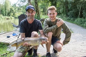 two men with a caught fish
