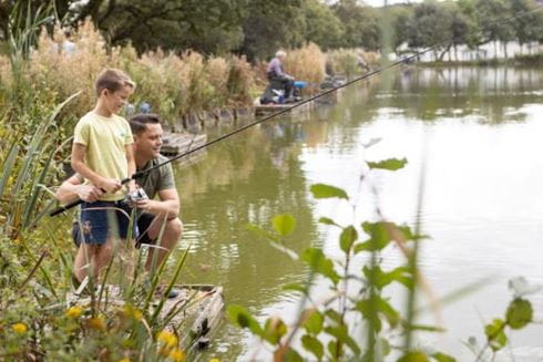 a man and his son fishing at a lake